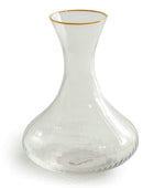 Clear glass decanter with gold rim on a white background