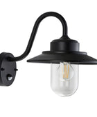 Black wall-mounted outdoor light fixture with clear glass shade on a white background