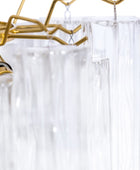 Clear shower curtain with gold hooks on a white background