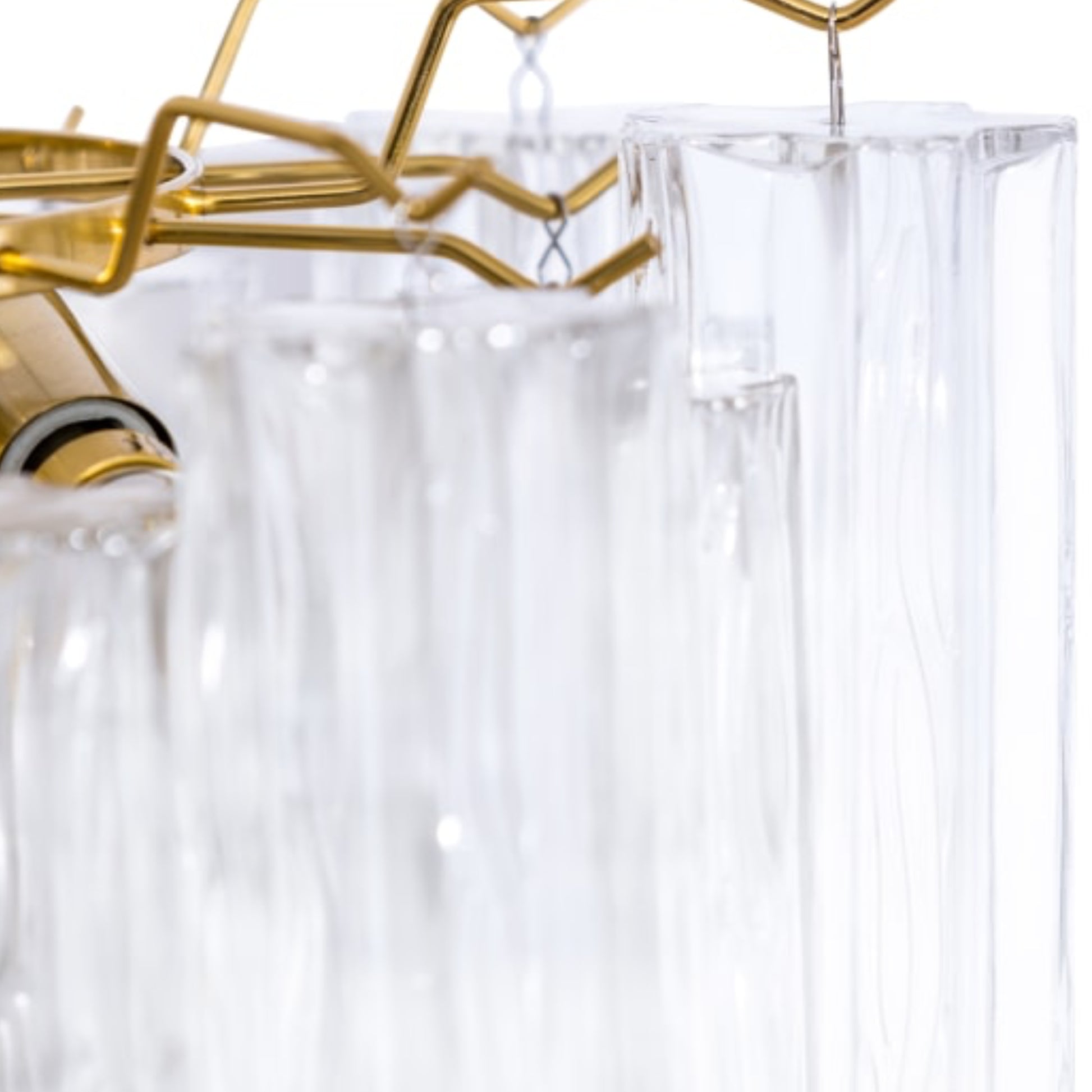 Clear shower curtain with gold hooks on a white background