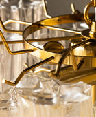 Close-up of a gold chandelier with clear glass shades.