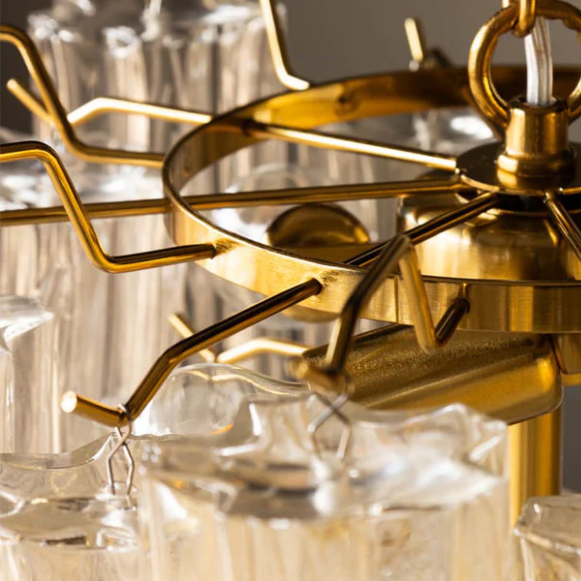 Close-up of a gold chandelier with clear glass shades.