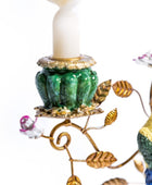 Decorative candle holder with birds and leaves on a white background