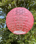 Pink lace lantern hanging among green trees