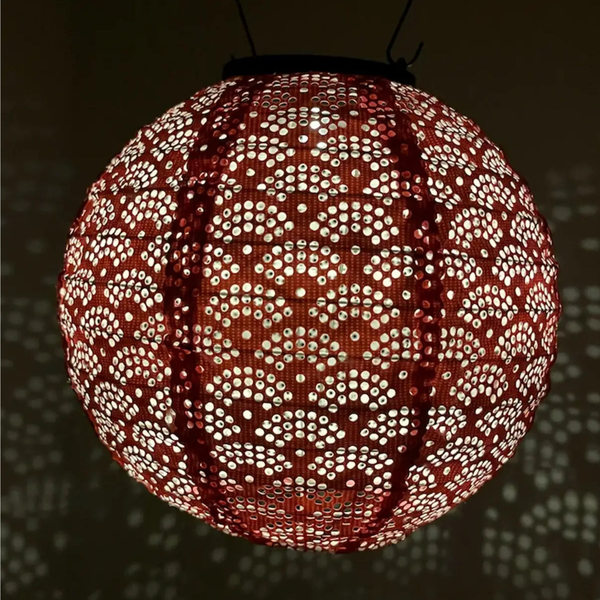 Decorative spherical lamp with intricate pattern on a dark background