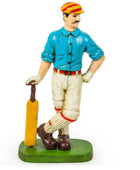 Figurine of a cricket player holding a bat on a white background