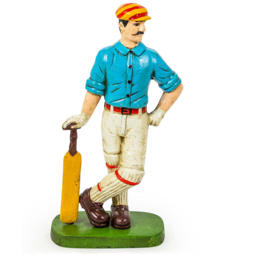 Figurine of a cricket player holding a bat on a white background