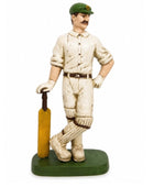 Statue of a cricket player holding a bat on a white background
