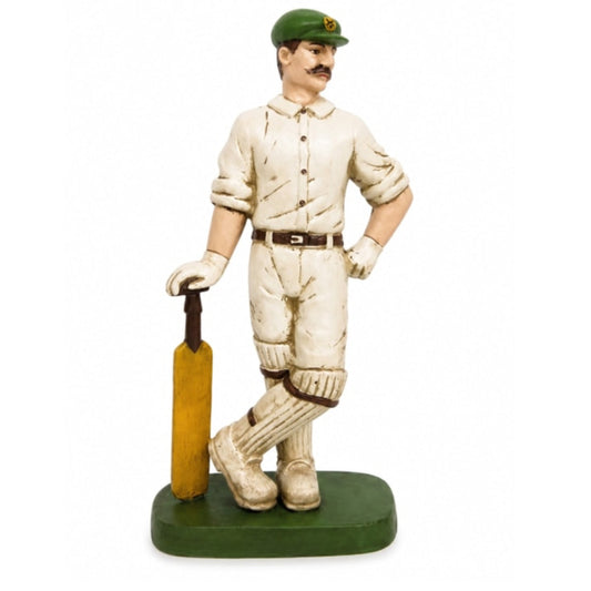 Statue of a cricket player holding a bat on a white background