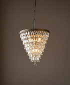 Chandelier hanging against a dark brown background