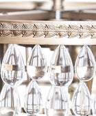 Decorative glassware hanging from a gold metal rack with intricate designs.