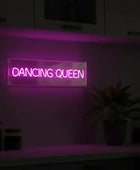 Neon sign with 'Dancing Queen' text on a dark background