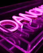 Neon sign with the word 'Dance' in pink on a black background