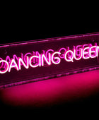 Neon sign with 'Dancing Queen' text on a black background
