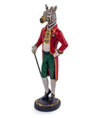 Statue of a zebra in formal attire with a red coat and green pants on a white background