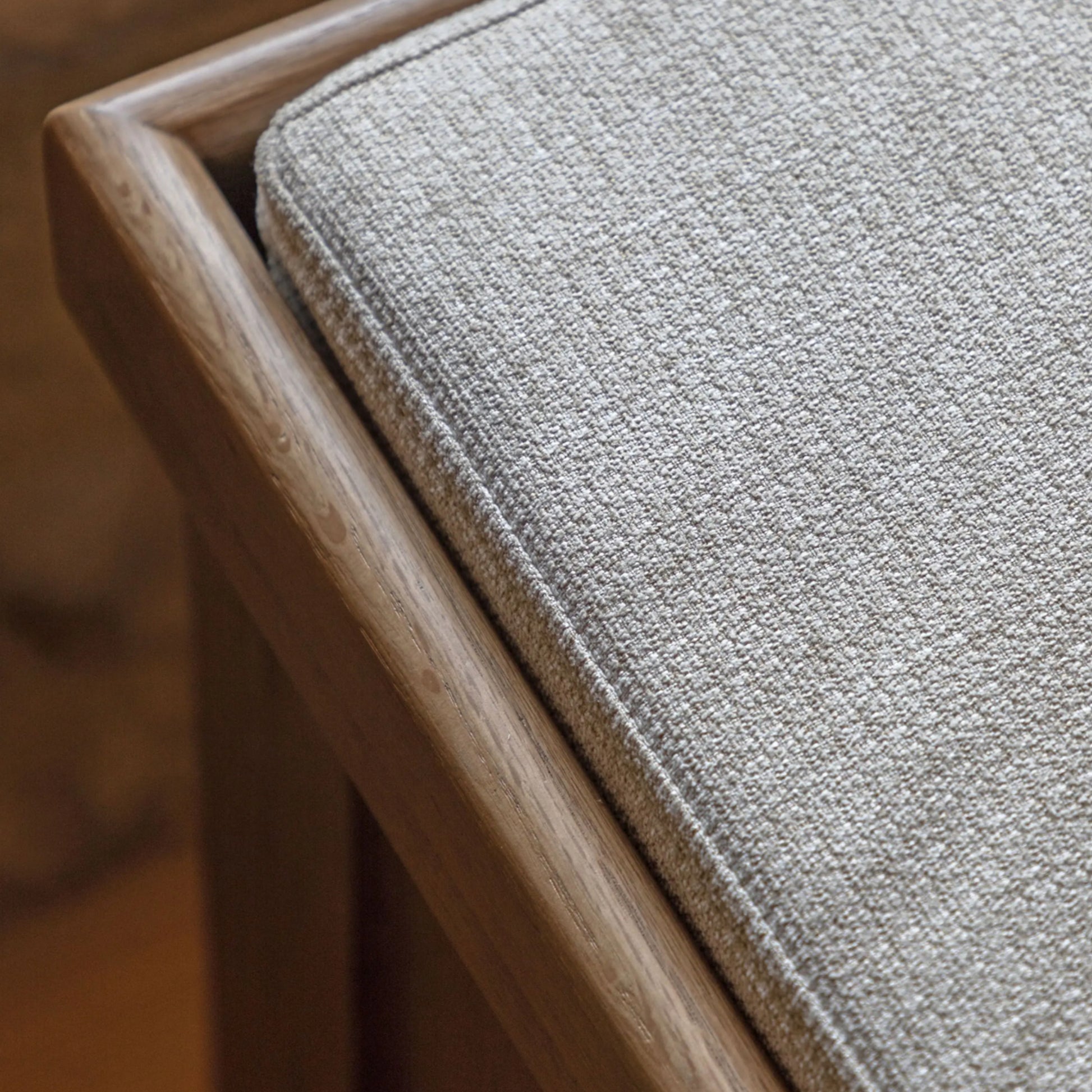 Close-up of a textured gray cushion on a wooden chair