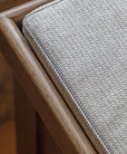 Close-up of a textured gray cushion on a wooden chair