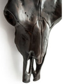 Bronze sculpture of a horse's head on a white background