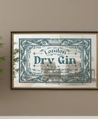 Framed advertisement for London Dry Gin on a wall with a plant to the left.