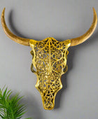 Decorative gold bull skull with long horns on a white background