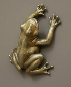 Bronze monkey figurine on a textured stone surface