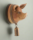 Pig head wall decoration with a bell on a white background