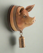 Pig head wall decoration with a bell on a white background