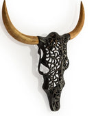 Decorative wall art with black filigree design and wooden horns on a white background