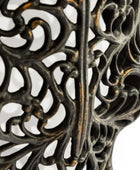 Close-up of a decorative metal stand with intricate patterns on a white background