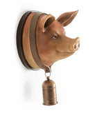 Pig head wall decoration with a bell on a white background