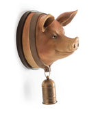 Pig head wall decoration with a bell on a white background