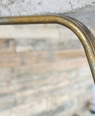 Close-up of a metallic object with a reflective surface on a blurred background