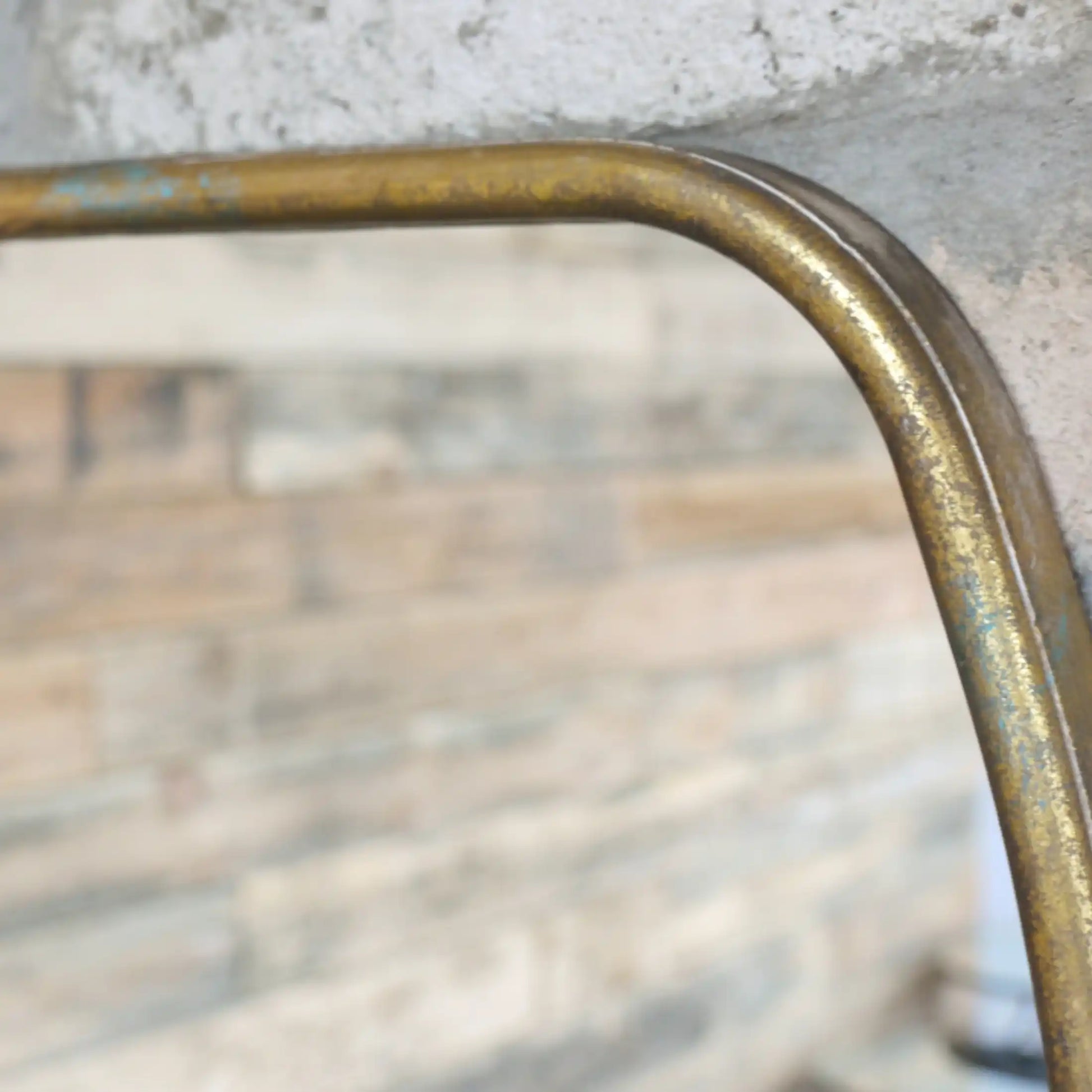 Close-up of a metallic object with a reflective surface on a blurred background