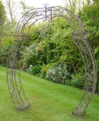 Decorative garden archway in a lush green garden setting