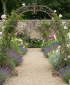 Decorative garden archway with flowers and a stone path