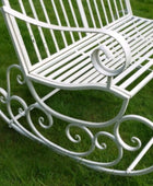 White metal rocking chair on a grassy background