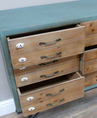 Wooden dresser with open drawers against a white wall