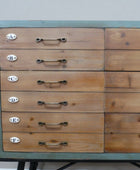 Wooden drawer unit with metal handles on a gray background