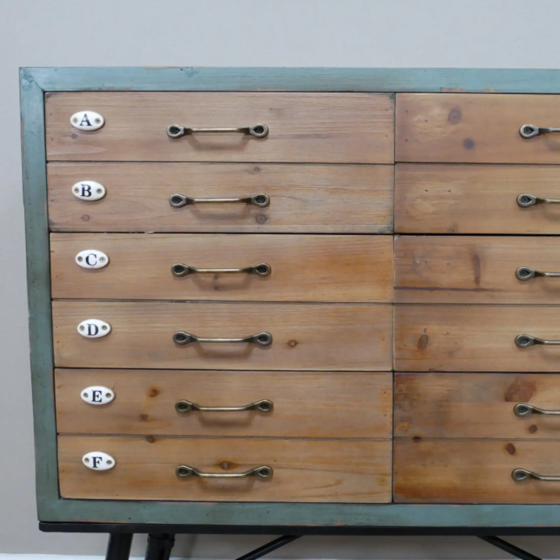 Wooden drawer unit with metal handles on a gray background