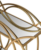 Gold-framed mirror with wavy design on a white background