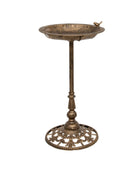Bronze bird bath with decorative stand on a white background
