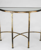 A semi-circular console table with a distressed gold metal frame and a dark glass tabletop, shown against a neutral light gray background.