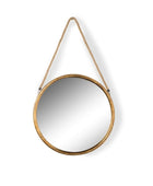Round mirror with gold frame and rope hanging on a white background