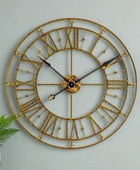 Gold wall clock with Roman numerals on a white background