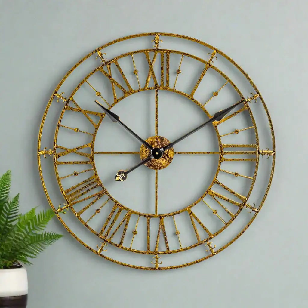 Gold wall clock with Roman numerals on a white background