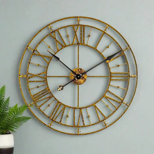 Gold wall clock with Roman numerals on a white background