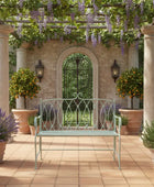 Garden setting with a bench, potted plants, and a stone archway.