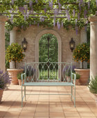 Decorative garden bench under a wisteria-covered pergola with potted plants and columns.
