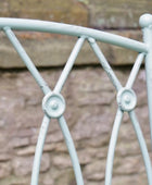 Metallic decorative railing with a stone wall background