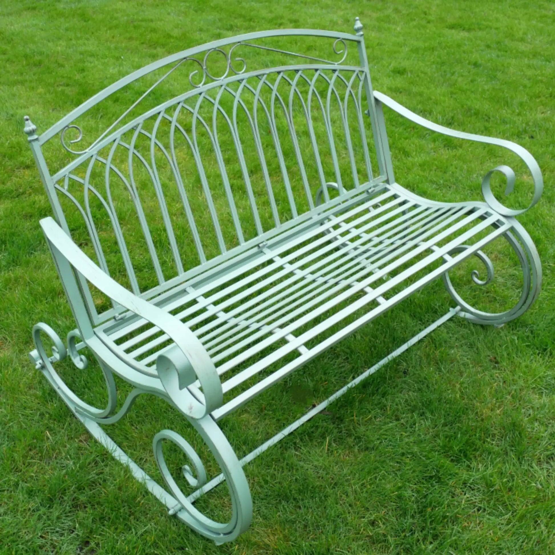 Decorative metal bench on a grassy background